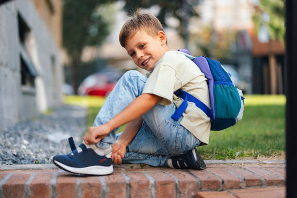 A smiling child with a backpack ready for the first day of school